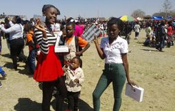 Young girls take free condoms. More than 120 000 condoms were distributed among young people at the 2014 Agricultural and Commercial Show of Zambia.