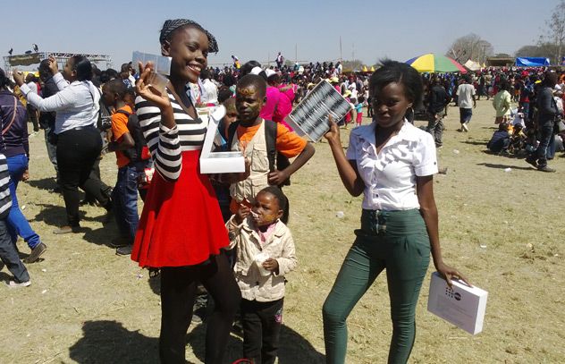 Young girls take free condoms. More than 120 000 condoms were distributed among young people at the 2014 Agricultural and Commercial Show of Zambia.