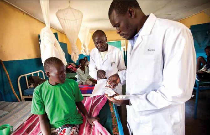 Doctors reviewing a patient's medication in a rural TB clinic, South Sudan. Credit: John Rae Photography