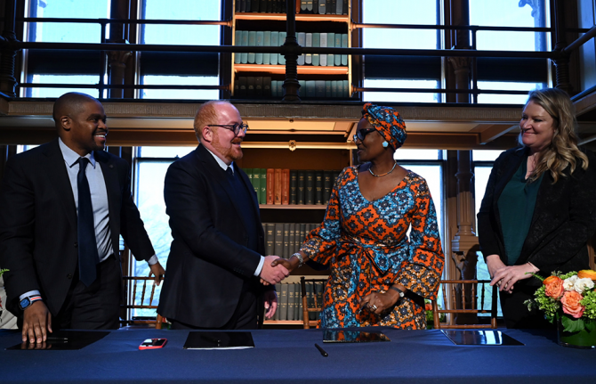 The agreement formalizing UNAIDS Collaborating Center was signed April 12 at Georgetown by (l to r) Christopher King, dean of the School of Health; Matthew Kavanaugh, director of the Global Health Policy and Politics Initiative and assistant professor in 